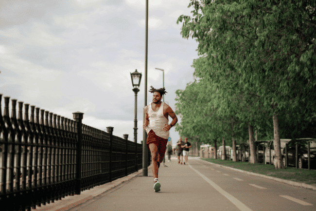A man jogging near the peer